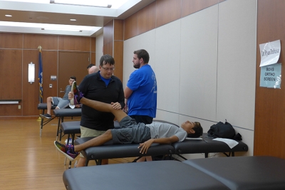 sports medicine physical day - doctors assisting patients